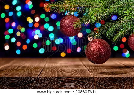 Red and green themed Christmas background on a mahogany with colored textures and copy space for your holiday wishes.