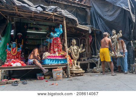 KUMARTULI KOLKATA INDIA - OCTOBER 10 2014 - Artist preparing clay idol to be worshipped as Goddess Kali during Kali Puja Hindu festival of Deepavali or Diwali. Celebtated all over India.