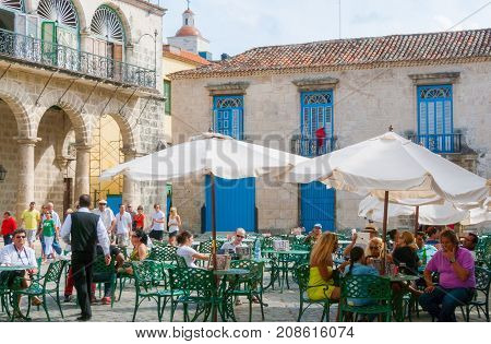 February 2012 Havana - During this time of year in Havana City tourist rest in Cathedral Square after long walks in town and chat while are drinking fresh sodas