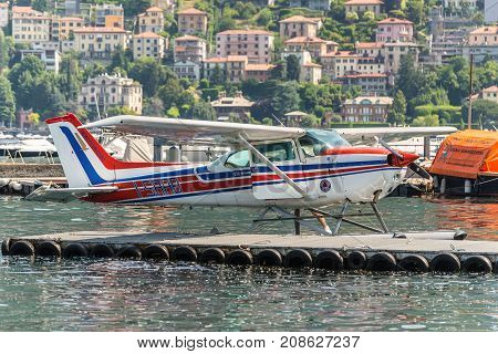 Como Italy - May 27 2016: A seaplane Cessna 172N Skyhawk 100 II docking on at water aerodrome of Como lake in Como City Italy.