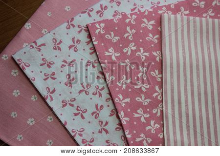Multicolored cuts of fabric against the background of boards