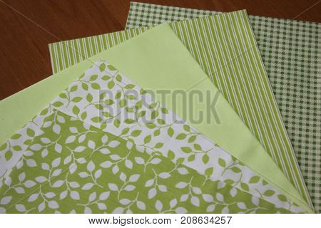 Multicolored cuts of fabric against the background of boards