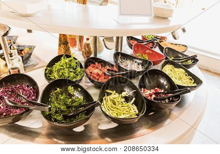 Salad black bowls with fresh vegetables buffet breakfast