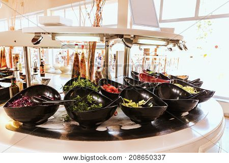 Salad black bowls with fresh vegetables buffet breakfast