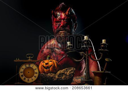 Halloween Devil Man With Pumpkin, Clock, Candlestick On Table