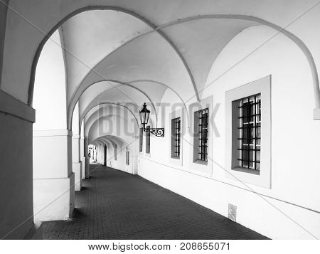 Old historical arcade in Loretanska Street near Prague Castle, Prague, Czech Republic. Black and white image