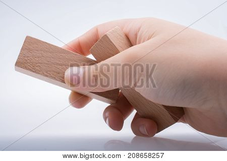 Hand Holding Wooden Domino
