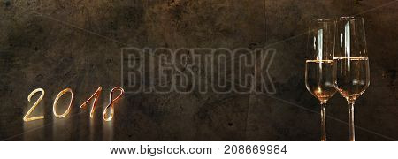 Concrete wall background with champagne for a new year congratulations card