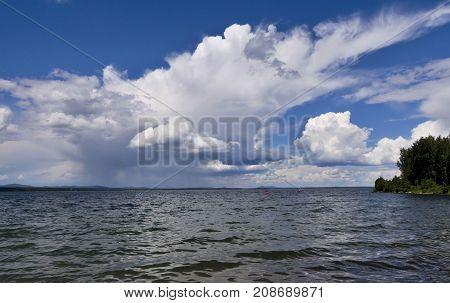 Bright Clouds Reflected In The Water