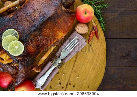 Goose baked in the oven with apples. Christmas goose on a wooden tray. Festive dish. Top view.