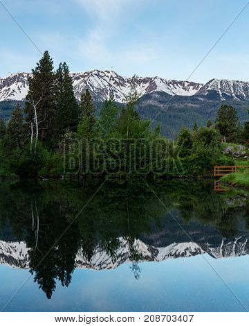 Wallowas in spring are reflected in a mountain pond, Oregon,