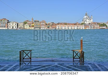 A view of the island of Dorsodoro in Venice taken from the island of Giudecca across the Giudecca Canal. The church of Santa Maria Della Salute (Saint Mary of Health) can be seen towering above the other buildings