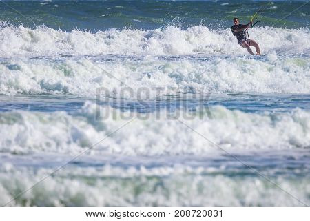 Young Atletic Man Riding Kite Surf On A Sea