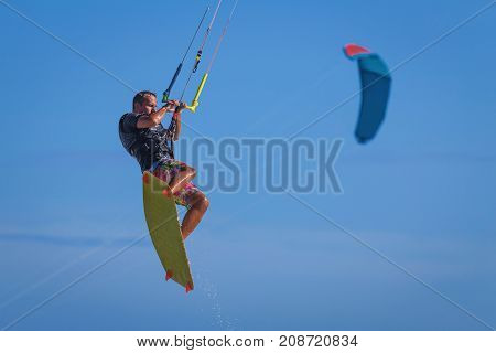 Young Atletic Man Riding Kite Surf On A Sea
