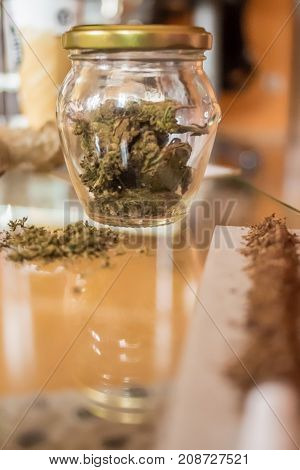 Medical Cannabis in jar and tobacco on a table