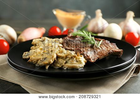 Plate with steak Diane on table