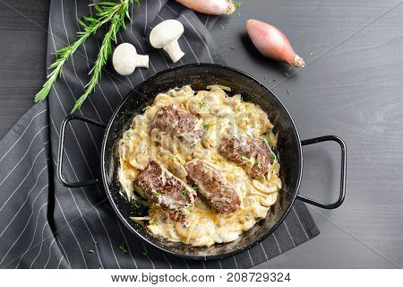 Dish with steak Diane on table