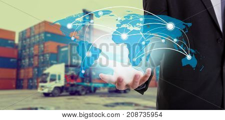 Global network coverage world map on hand of businessman Industrial Container Cargo freight ship at habor for Logistic Import Export background (Elements of this image furnished by NASA)