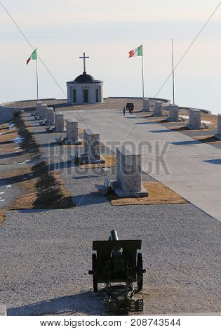 Vicenza VI Italy - December 8 2015: War Memorial of First War World called Ossario del Monte Grappa. Long main road and an ancient cannon