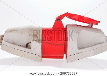 Red and white three-phase plug and socket isolated on white