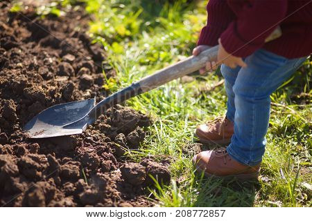 Little Kid Working In The Garden