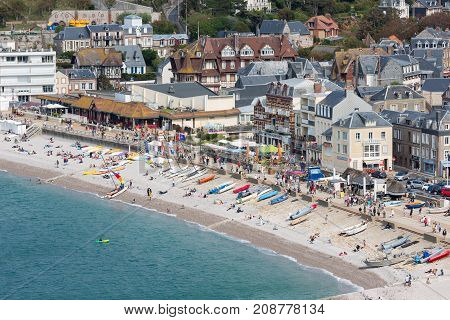 ETRETAT, FRANCE - AUGUST 25, 2017: Aerial view beach and promenade with tourists and seaside visitors of Etretat in Normandy, France