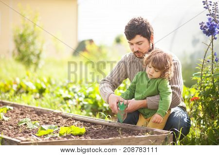 Father And Daughter Working Together In The Garden