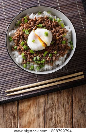 Japanese Spicy Beef Soboro With Egg Benedict, Rice And Green Onion Close-up. Vertical Top View