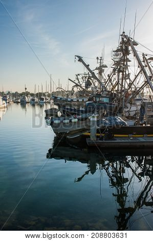 Combination of large and small fishing boats at dock.