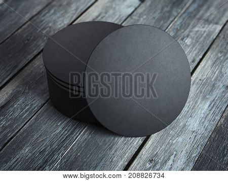 Black beverage coasters on the wooden floor. 3d rendering