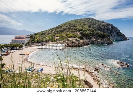 Enfola beach and sea. Elba Island, Italy. Tuscany. Aerial view of the Enfola beach paradise. Coast and sea. Vegetation and blue sky with some clouds.