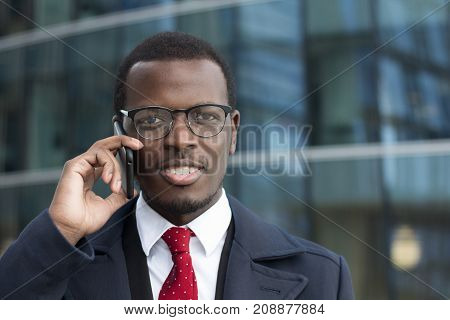Horizontal Portrait Of Young Dark-skinned Business Guy Dressed In Formal Clothes While Standing In S