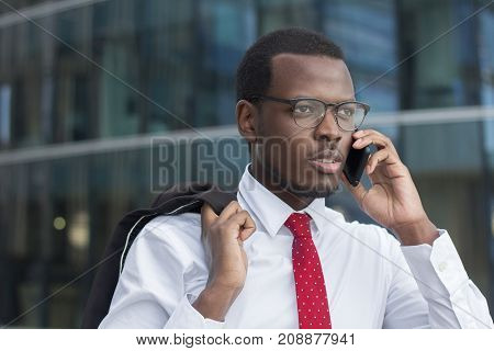 Outdoor Closeup Of Young Dark-skinned Business Guy Wearing White Formal Shirt, Red Tie And Black-rim
