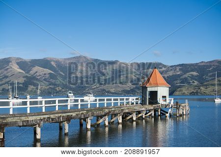 The landmark of Akaroa Daly's Wharf at sunset.