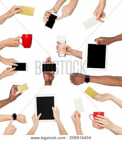Set of male and female hands holding items. Gadgets, business crads and coffee cup in various hadns. Isolated at white background