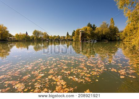 Autumn colors and reflection on Puigcerda's pond in Pyrenees. Located in north Catalonia, Spain.