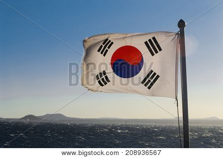 South Korea flag waving against clean blue sky close up isolated with clipping path mask alpha channel transparency