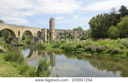 BESALU, SPAIN - JULY 26, 2017: Stone bridge of Besalu a medieval town of Girona Catalonia Spain.