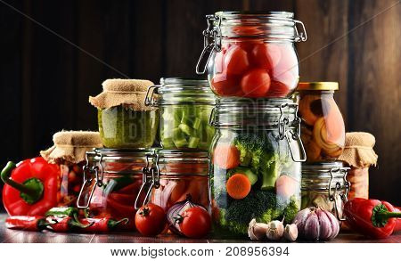 Jars With Marinated Food And Organic Raw Vegetables