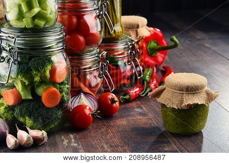 Jars With Marinated Food And Organic Raw Vegetables