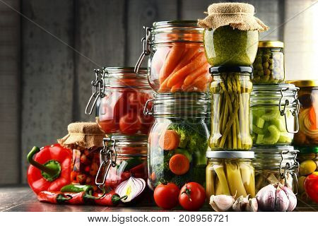 Jars With Marinated Food And Organic Raw Vegetables