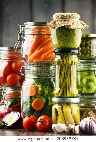 Jars With Marinated Food And Organic Raw Vegetables