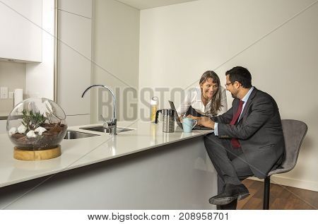 Arab Man Woking In His Laptop In The Kitchen