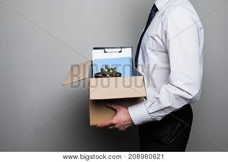 Cropped Shot Of Fired Businessman Packing Office Supplies In Cardboard Box At Workplace