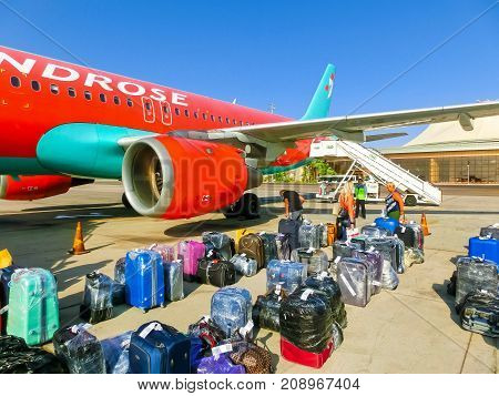 Sharm El Sheikh, Egypt - September 28, 2017: The passenger walking to the rear entrance of airplane at day at Sharm El Sheikh, Egypt on September 28, 2017