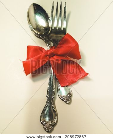 Dinner set with red ribbon tied in the middle.
