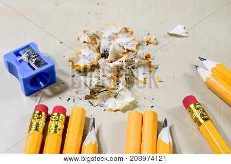 Crayons And Pencil Sharpener On A Wooden Office Table. Crayons With Sharpening Crayons And Pencils O