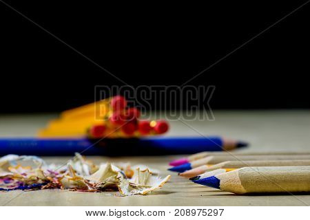 Crayons And Pencil Sharpener On A Wooden Office Table. Crayons With Sharpening Crayons And Pencils O