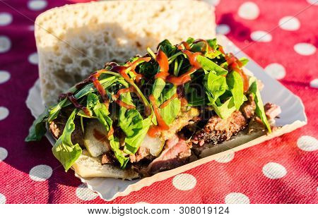 Sandwich With Slow Cooked Smoked Beef And Bbq Sauce At A Street Food Market