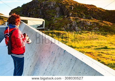 Tourist Woman With Norwegian Flag Enjoying Sea Coast View From Bukkekjerka Rest Stop Area On Andoya 